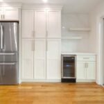 Cream pantry cabinet wall with beverage cooler and stainless refrigerator