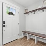 Mudroom built-in bench with coat hooks and wood shelf