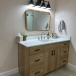White oak bathroom vanity with black hardware and stone countertop